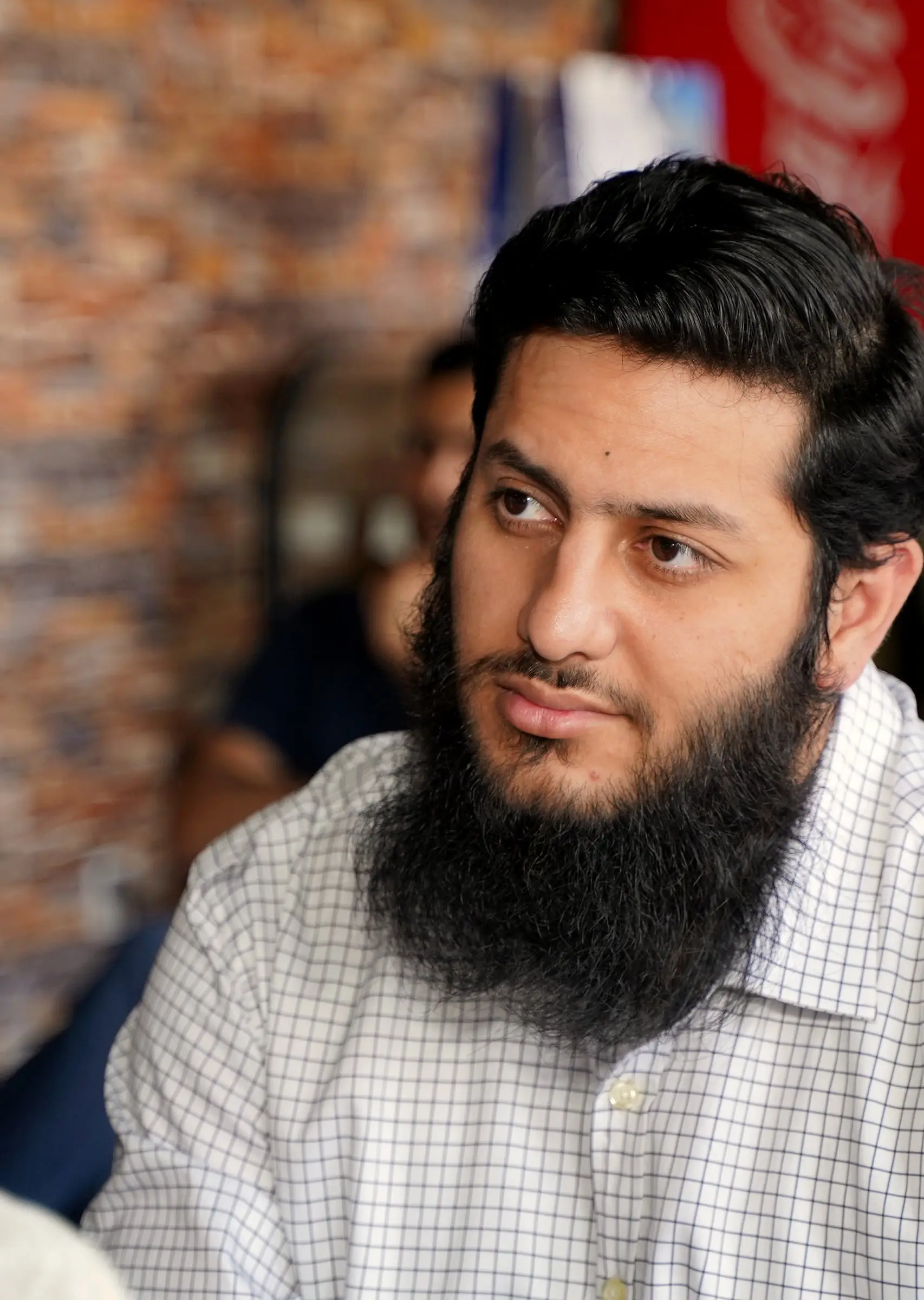 Usman listening to a question during a teaching session