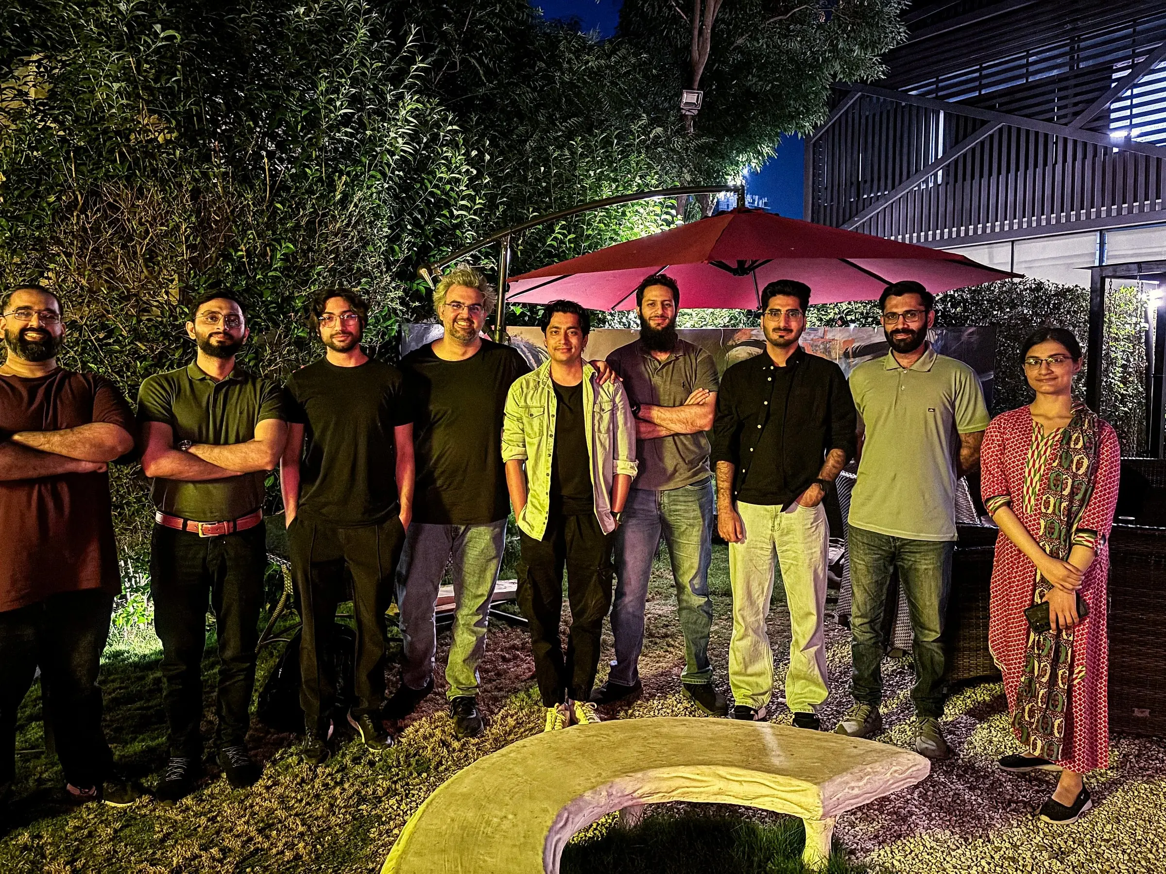 Usman with founders and builders at an evening meetup in a garden