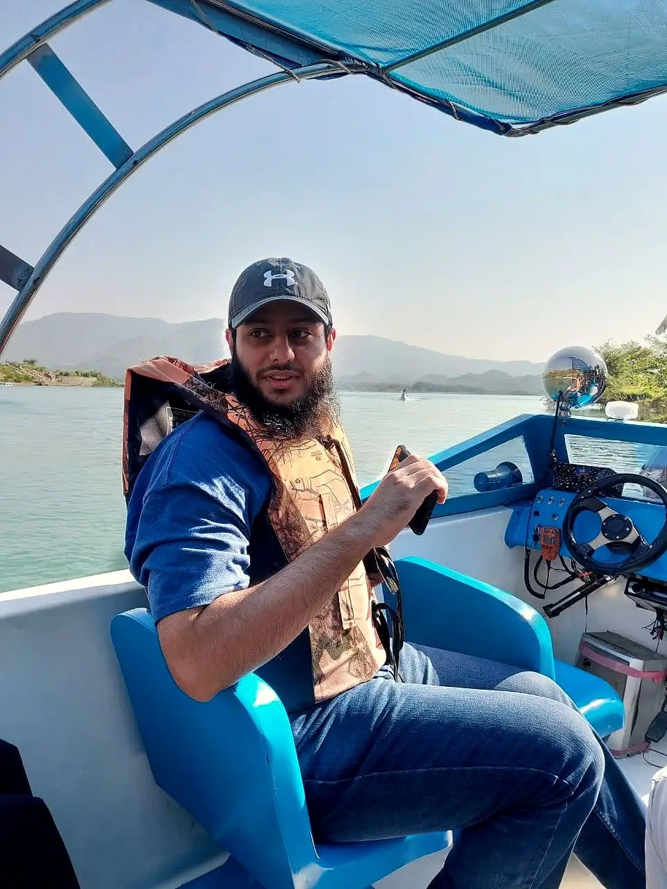 Usman on a boat on a lake