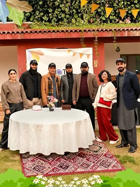 Usman with colleagues at an outdoor award day