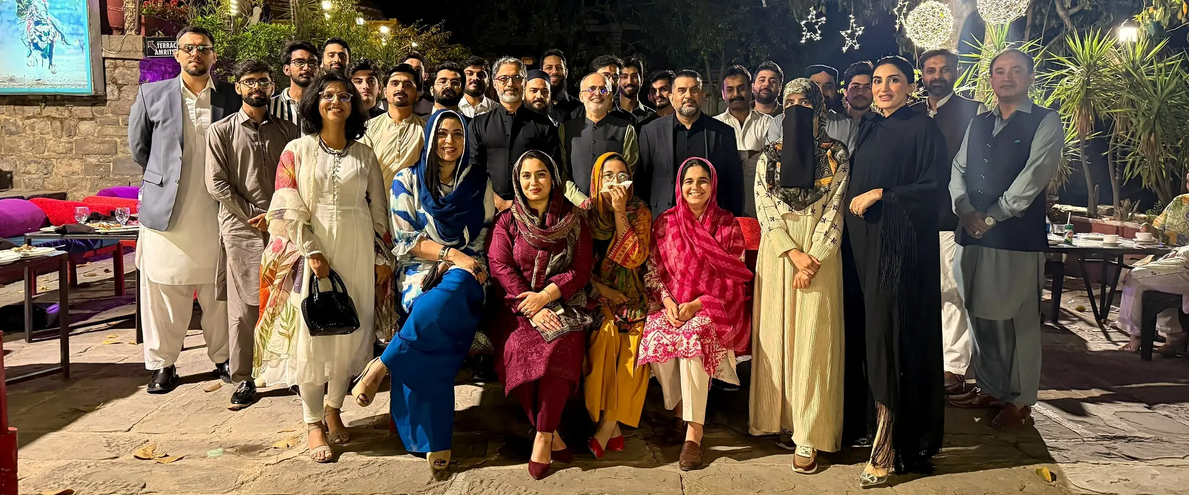 Usman, standing at the back, with the IOTA team at an evening dinner in Islamabad