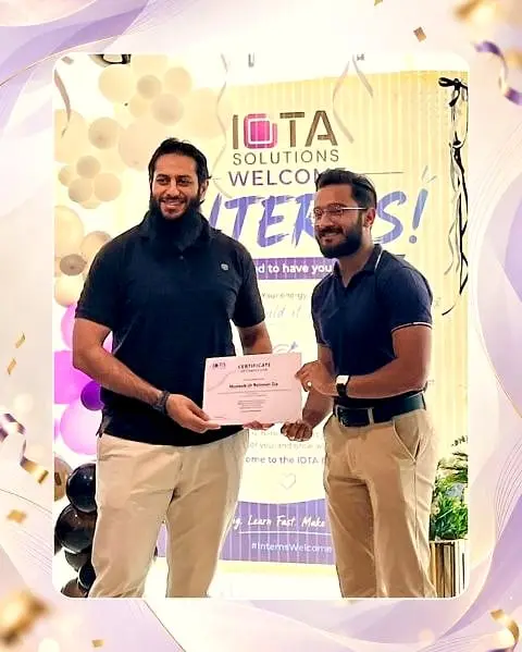 Usman presenting a certificate to an intern