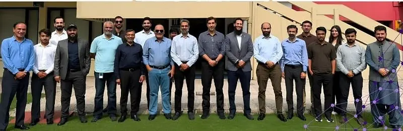 Usman with a large group of workshop participants outdoors